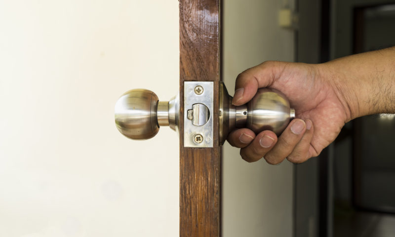 hand opening door, house door open, house door knob, house insurance malta, home insurance malta